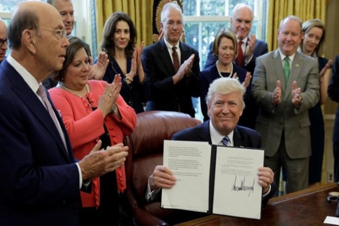 President Donald Trump eased up on demands to include funding for a southern border wall in any budget pact, clearing a major obstacle in the negotiations.(Reuters)