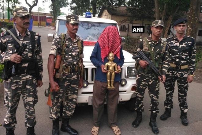 In a successful attempt by the Sashastra Seema Bal personnel, a person has been detained while trying to smuggle an 'Ashtadhatu' (metallic) idol near Siliguri in West Bengal from a place along Indo-Nepal border. (ANI) In a successful attempt by the Sashastra Seema Bal personnel, a person has been detained while trying to smuggle an 'Ashtadhatu' (metallic) idol near Siliguri in West Bengal from a place along Indo-Nepal border. (ANI)