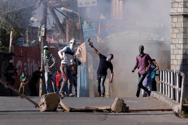 Demonstrators hurl stones towards policemen during a protest in Srinagar, against the recent killings in Kashmir region. (File Photo: Reuters)