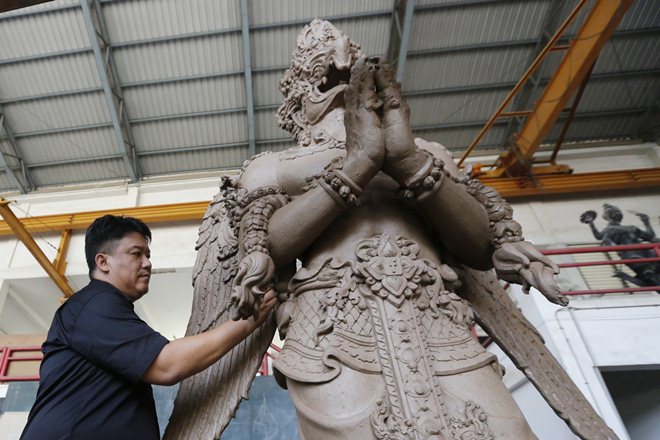  The Apple and Google logos were nestled in the centre of each of the Garuda's wings while a Facebook logo was etched onto the animal's belt buckle. (AP)