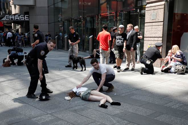 An injured woman is seen on the sidewalk in Times Square after a speeding vehicle struck pedestrians on the sidewalk in New York City. (Reuters)