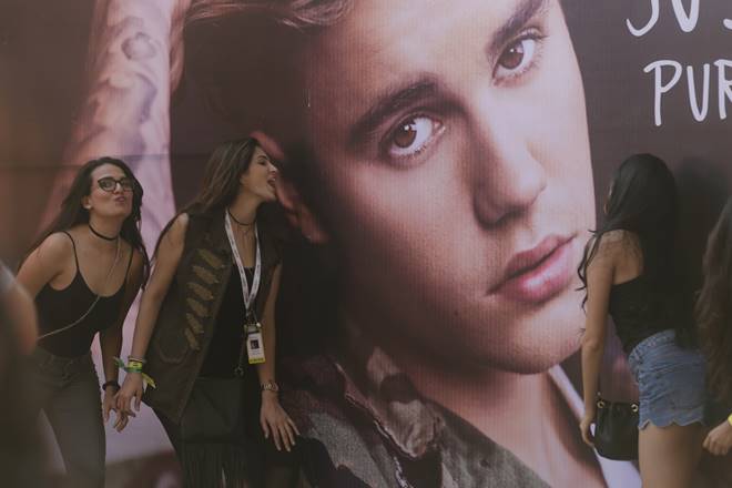 Fans of Canadian singer Justin Bieber pose for photographs in front his poster ahead of a concert by him in Mumbai. (Associated Press) Fans of Canadian singer Justin Bieber pose for photographs in front his poster ahead of a concert by him in Mumbai. (Associated Press)