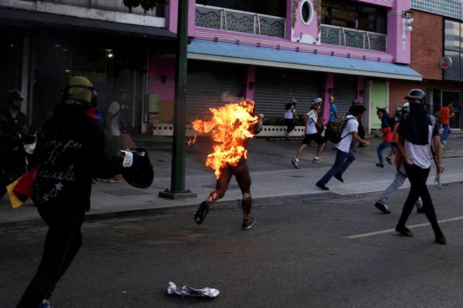 Photographer Marco Bello has covered many violent scenes during seven weeks of anti-government protests in Venezuela, but he witnessed a particularly shocking incident at the weekend when a crowd set a man on fire. (Reuters) Photographer Marco Bello has covered many violent scenes during seven weeks of anti-government protests in Venezuela, but he witnessed a particularly shocking incident at the weekend when a crowd set a man on fire. (Reuters)