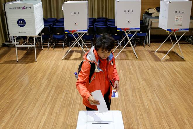 A woman casts her vote at a polling station during the presidential elections in Seoul, South Korea. (Reuters)