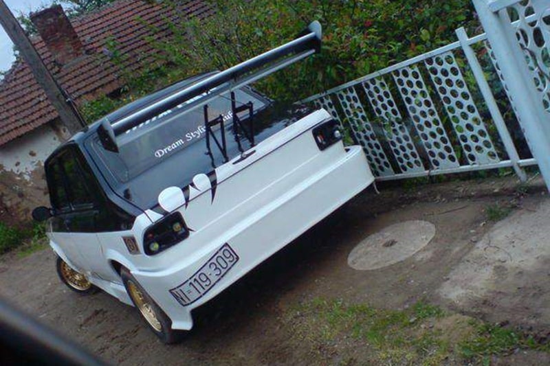 Spoilers are meant to provide downforce for extremely fast cars. Wake up man, this isn't an extremely fast car. And is the licence plate supposed to highlight his creativity?