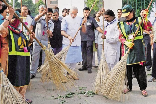 A file photo of Prime Minister Narendra Modi wielding a broom with NDMC workers to launch. (PTI) A file photo of Prime Minister Narendra Modi wielding a broom with NDMC workers to launch. (PTI)