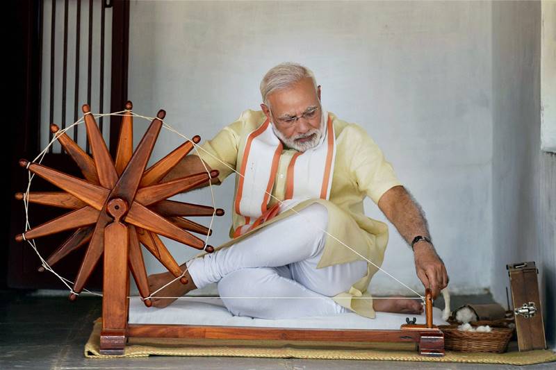 Narendra Modi in Gujarat, Narendra Modi in Gujarat pics, Modi spins charkha, modi spins charkha pics, modi spins charkha images, images of modi spinning charkha, pm modi in Sabarmati Ashram, Sabarmati Ashram, textiles India 2017 Summit, gujarat assembly elections, gujarat assembly polls date, bjp news, gujarat news, ahmedabad, Gandhinagar, bjp, bjp news, modi pics, gujarat pics, sabarmati ashram pics
