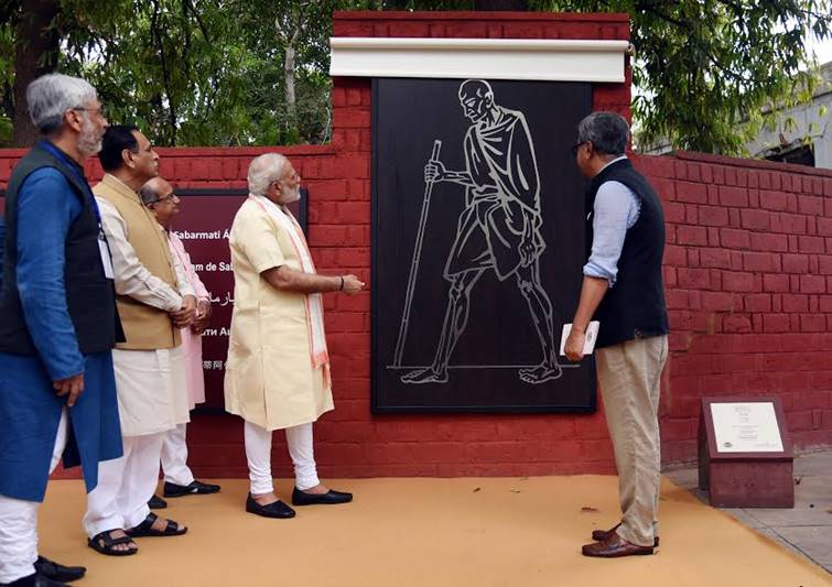 Narendra Modi in Gujarat, Narendra Modi in Gujarat pics, Modi spins charkha, modi spins charkha pics, modi spins charkha images, images of modi spinning charkha, pm modi in Sabarmati Ashram, Sabarmati Ashram, textiles India 2017 Summit, gujarat assembly elections, gujarat assembly polls date, bjp news, gujarat news, ahmedabad, Gandhinagar, bjp, bjp news, modi pics, gujarat pics, sabarmati ashram pics