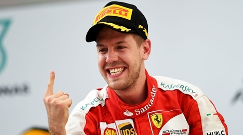 KUALA LUMPUR, MALAYSIA - MARCH 29: Sebastian Vettel of Germany and Ferrari celebrates on the podium after winning the Malaysia Formula One Grand Prix at Sepang Circuit on March 29, 2015 in Kuala Lumpur, Malaysia. (Photo by Lars Baron/Getty Images)