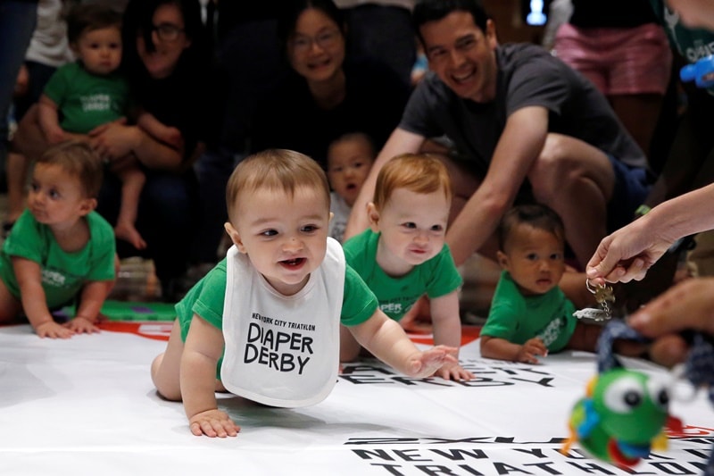 Race time: In a race of laughter and false starts, 30 toddlers battled it out for glory in a three-metre crawling contest in New York on July 14. The rule of the race was simple: babies cannot stumble on their feet, though parents were allowed to encourage their kids with bottles of milk, television remote controls or key jangling. Take a look at the cutest pics of crawling babies. And yes, there are some winners too. (All images by Reuters)