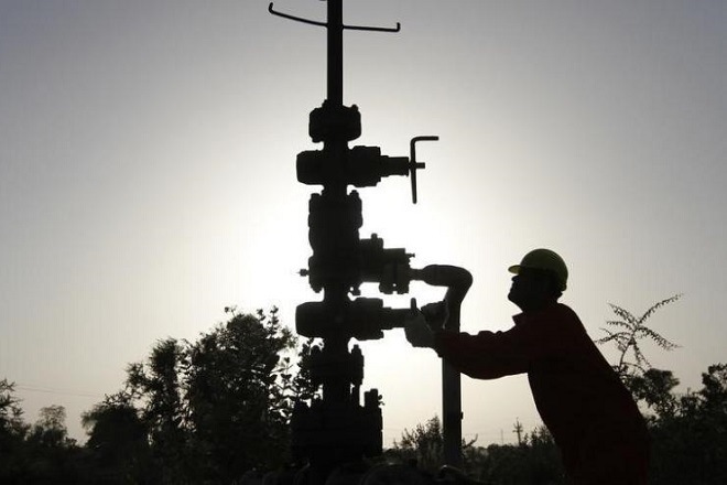 A technician opens a pressure gas valve inside the Oil and Natural Gas Corp (ONGC) group gathering station on the outskirts of Ahmedabad March 2, 2012. REUTERS/Amit Dave/Files