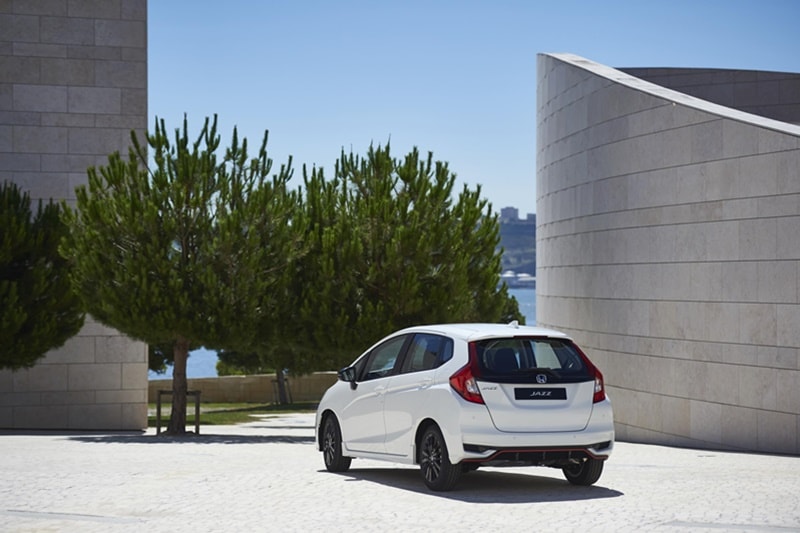 Shallower grille sections are linked by a gloss black trim strip above a trapezoid lower section.