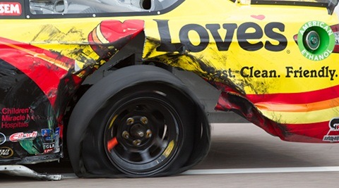 March 2, 2014: David Gilliand, driver of the #38 Love's Travel Stops Ford rolls down pit row with a flat tire during todays 10th Annual The Profit on CNBC 500 presented by Small Business Fueling America at Phoenix International Raceway in Phoenix, AZ. (Photo by Brad Schloss/Icon SMI/Corbis via Getty Images)