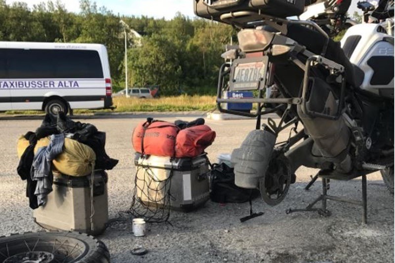 But it isn't always fun and games while doing cross-country or cross-continent runs like these. Pictured here is what Tim calls 'roadside maintenance'. 'Just a routine brake pad swap,' he says.
