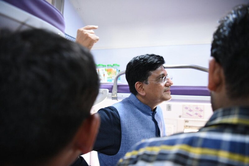 What makes this train class apart from general trains is its plush interiors. The special features include: Modular panels, Ergonomically designed ladders for climbing to the upper berth, appealing toilet modules with big mirror, controlled discharged water. (Railway Minister Piyush Goyal interacts with Mahamana Express train passengers.)