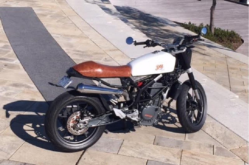 Australia's Yuls Customs has an elaborate CV, including crafting of anodized aluminium and stainless steel for the Marine industry, and their rendition of a Duke. This was built on order from a woman motorcyclist to best her body type and specific requirements. The result is a simple, yet fantastic looking scrambler. (Image: The Moto Lady)