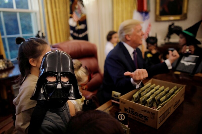 President Donald Trump meets with children dressed in their Halloween costumes in the Oval Office of the White House. (Reuters Photo)