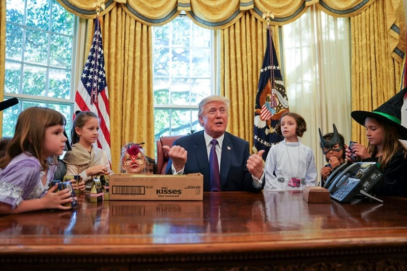President Donald Trump meets with children dressed in their Halloween costumes in the Oval Office of the White House on Friday. The White House had invited the children of members of the media to visit the president and to trick-or-treat at the White House complex of the Eisenhower Executive Office building. (AP Photo)