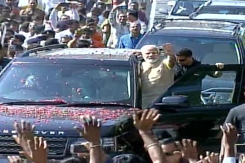 Pictures from Vadnagar, which is the hometown of PM Modi. The streets were lit up on the eve of his visit. PM Narendra Modi is seen during a roadshow at Vadnagar. (Source: Twitter/ANI)