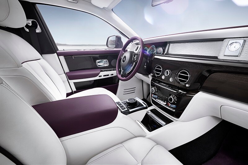 The dashboard of the Rolls-Royce Phantom pays homage to the company's model of the past with one clean symmetrical surface. It gets a 12.3 inch touchscreen infotainment system. The standard clock features a dark face and the surround is finished in black leather.