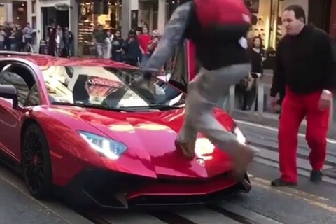Watch video: Crazy man climbs over Lamborghini Aventador SV, outraged owner knocks him out