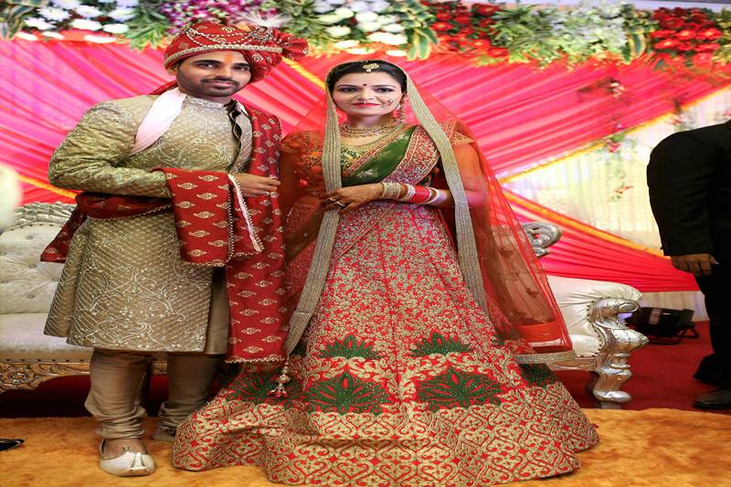 Team India speedster Bhuvneshwar Kumar married his childhood sweetheart Nupur Nagar today in Greater Noida. His relatives and friends who had gathered for the occasion can be seen celebrating. Bhuvneshwar himself was dressed in a striking outfit while Nupur was resplendent in a red and green sari and jewellery to match. However, most of his cricketing comrades, including skipper Virat Kohli, could not make it as tomorrow they play in the second Test against Sri Lanka in Nagpur. Bhuvneshwar himself had taken time off from Team Idnia to get married. The duo made a striking couple. Check out the spectacular photos here (PTI):