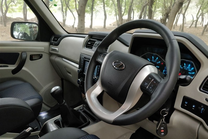 On the inside, the new Mahindra Scorpio gets faux leather seats, faux leather wrapped steering and gear lever, new roof mounted sunglass holder and enhanced storage spaces. It also features a reverse parking camera with dynamic assist, new one-touch lane change indicator and new auto window roll-up. Safety is covered by dual front airbags, anti-lock braking system (ABS), collapsible steering column & side intrusion beams, panic brake indication, engine immobiliser, panic brake indicator, anti-theft warning, speed alert, among others.