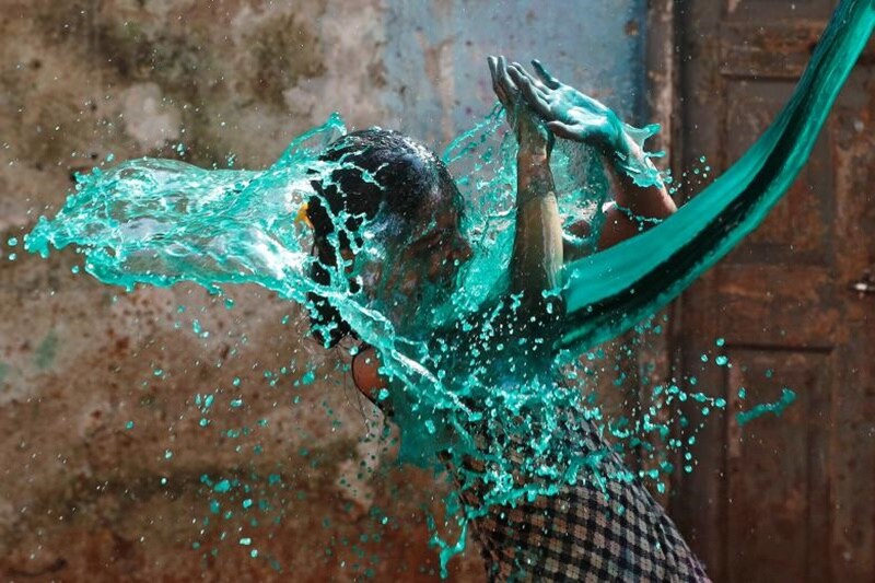 A girl reacts as colored water is thrown on her face while celebrating Holi, the Festival of Colours, in Mumbai, India, March 13. (Source: Reuters)