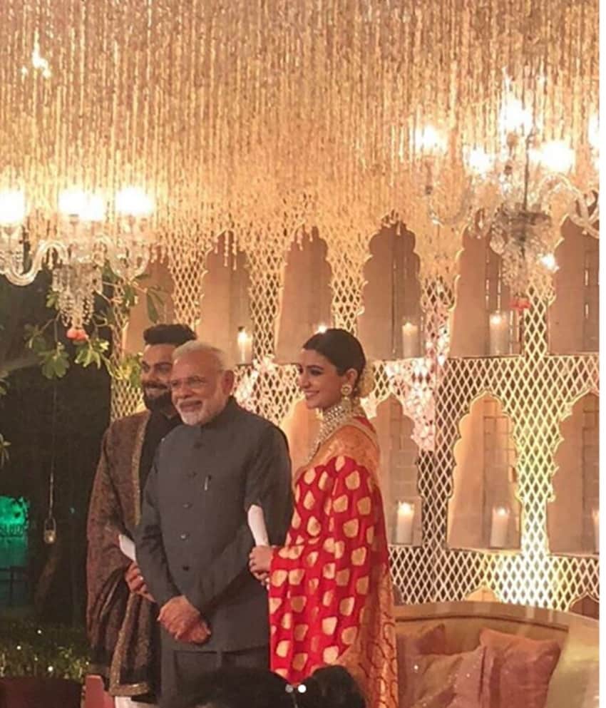 Prime Minister Narendra Modi attended the Delhi reception held for Anushka Sharma and Virat Kohli. The couple looks happy and obliged to the PM for his arrival. (Source: IE)