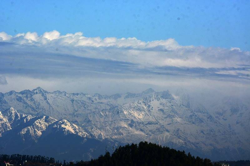 After the snowfall yesterday, snow covered mountains appearing far from the Shimla and the sun light reaches the mountains and the snow shining like the silver in the pleasant weather, Shimla on Thursday. (Image: Indian Express Photo)