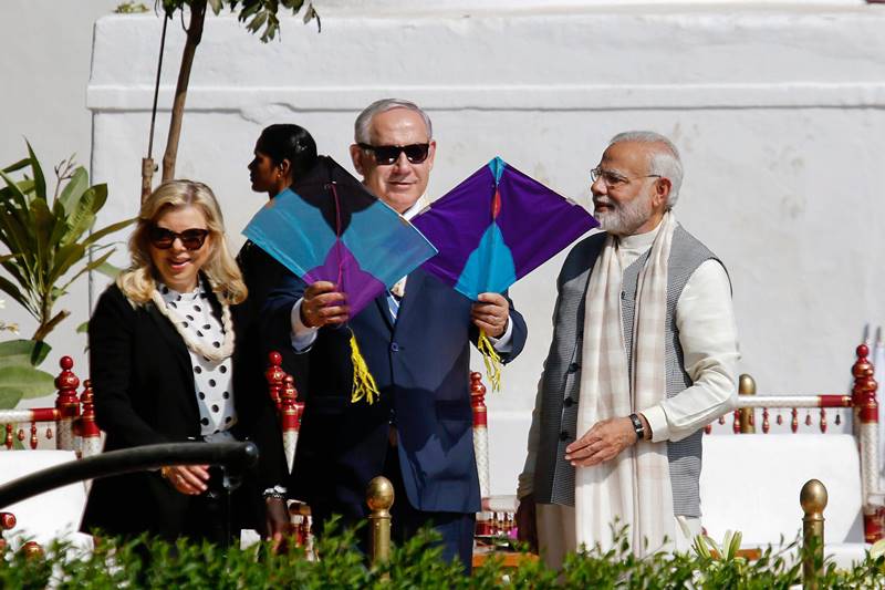 PM Modi and Israel PM Netanyahu and his wife Sara Netanyahu fly a kite at Sabarmati Ashram. (PTI Photo)