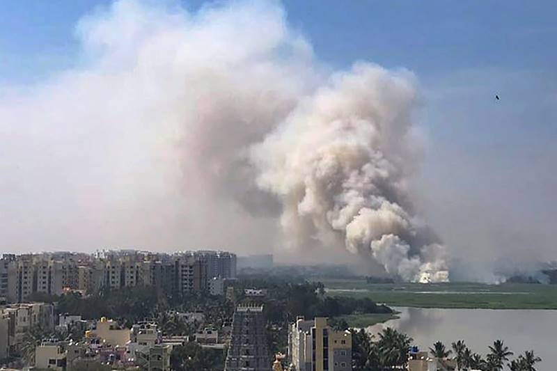 A huge fire emanated from the highly polluted Bellandur lake, the biggest water body of the city, giving anxious moments to hundreds of residents living nearby. The locals noticed huge clouds of smoke billowing from the lake replete with sewage, chemical effluents and construction debris. The fire was in the middle of the wetlands, fire brigade officials said. Soon pictures and videos of the smoke and fire went viral even as various government agencies and Defence personnel doused the blaze, which also raised concerns about apathy of civic agencies towards a recurring problem in the lake. According to Defence officials, a strong contingent of 5,000 army jawans of the ASC centre led by Major General N S Rajpurohit doused the fire in the lake. (PTI Photo)
