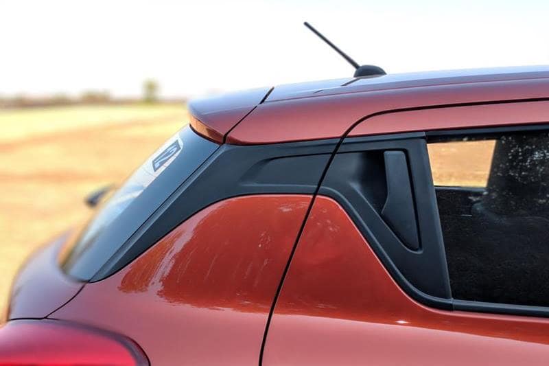 xThe rear door of the 2018 Maruti Suzuki Swift gets a neat and clean finished look with an aggressive line running along the side of the car. The rear door handle position has moved up on to the window of the car and will take time for one to get used to that. The quality of the plastic door handle could have had been better.