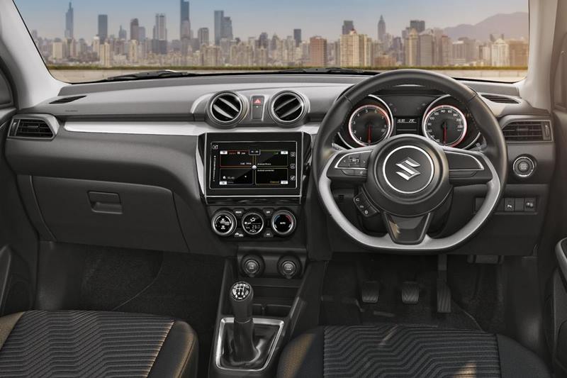 Interiors of new 2018 Maruti Suzuki Swift reflect's a sporty and modern cabin with a neat overall layout of the dashboard. The cockpit design of the interior is enhanced by driver-side tilted HMI (human-machine interface) controls. The interiors are are finished in urbane satin chrome finish on the instrument panel, steering, doors and speedometer rings. The flat bottom steering wheel adds to the overall sportiness.