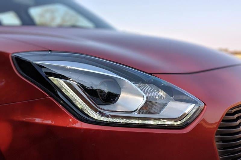 The top manual variants of the new Maruti Suzuki Swift features these aggressive LED lights on the headlamp cluster giving it a unique look from the outgoing Swift model. It also gets projector headlamps.