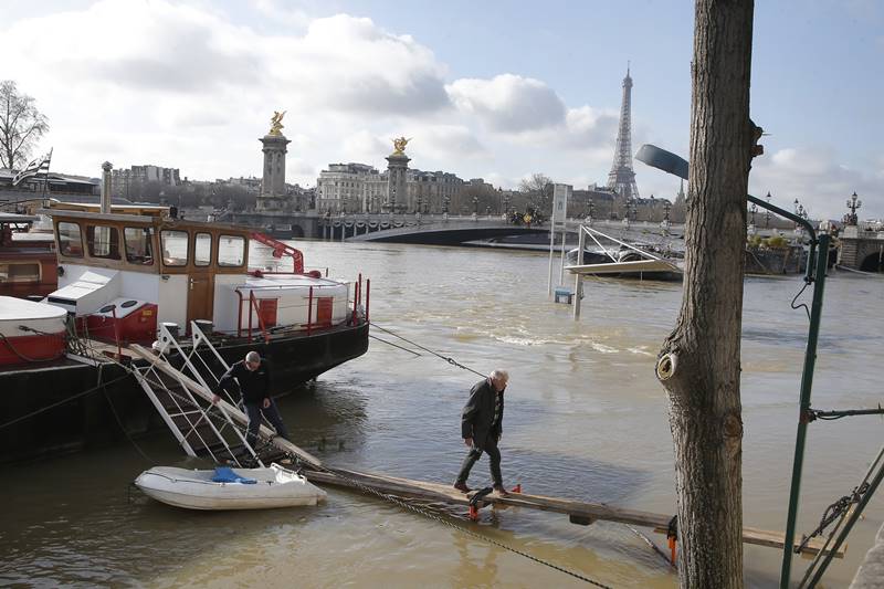 The Seine reached 5.44 meters (nearly 18 feet) by Thursday morning at the Austerlitz bridge in the east of the city. (AP Photo)