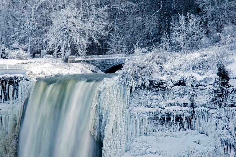 Meanwhile in Canada, water flows over the over the Bridal Veil Falls in Niagara Falls. Almost every year frigid temperatures transform the falls into an icy winter wonderland when the mist is blown back, freezing on the landscape. (AP Photo)