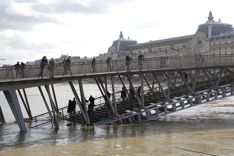 Rivers across France kept swelling as more rain hit the country Thursday, with 15 departments across the country remaining on alert for floods. In addition to Paris, where the Seine river is expected to keep rising until Saturday, the other regions threatened are in the north and east of the country. Four other departments in central France have been placed on alert for snow and ice. Meteo France said that exceptionally high levels of rain this winter were to blame for the floods, with rainfall in Paris twice as high as normal. (AP Photo)