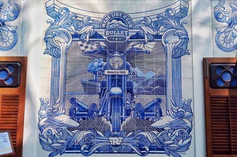 The wall art of the new Royal Enfield Garage Cafe is also unique in its own way. In contrary to what most of you might think, every tile on this wall has been painted individually as per the company. After that, these were baked in order to set the paint properly and last, all tiles were assembled on the wall.