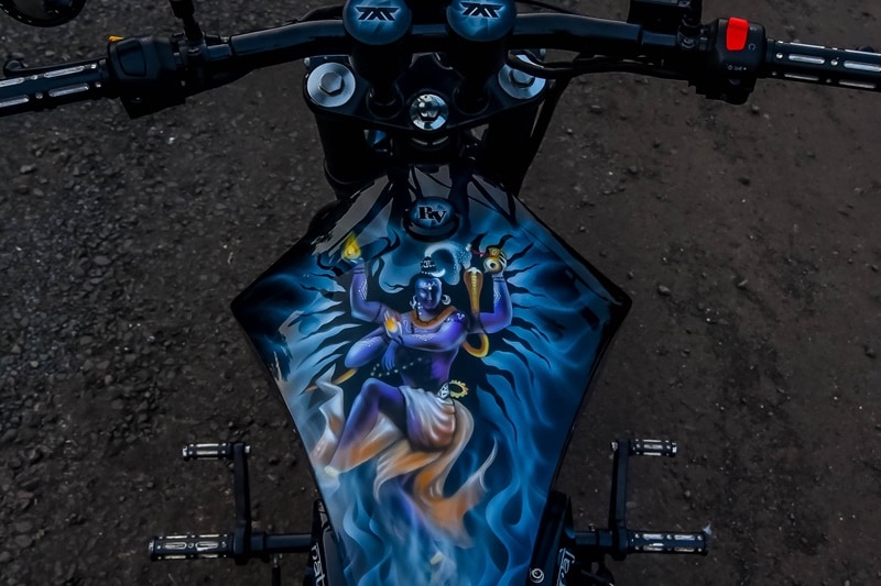 Royal Enfield, a motorcycle manufacturer with a name that has been a part of the lives of thousands of families in India. Your grandfather may have owned one or your dad or maybe you are proud owner of one of the most popular motorcycles India has ever seen. We've done lists and galleries on modified Royal Enfield motorcycles before, but can't seem to get enough as there is so much potential in RE bikes for custom jobs. Custom motorcycle builders from across the country have done their rendition of Royal Enfield Classic 500 or Classic 350 or Bullet 300 and 500, and even the Thunderbird series. We came across one that's inspired by Indian God, and how! See for yourself.