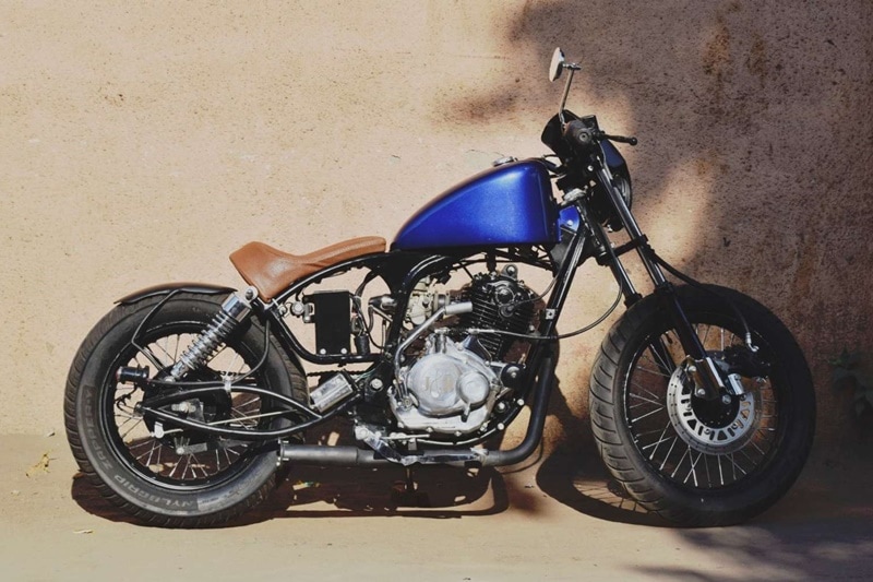 The Phantom: Bajaj Pulsar 180 served as the base for this modification done by Baroda based motorcycle custom outfit J&D Custom Co. Transformed into softail bobber, the donor Pulsar 180 was stripped and the J&D's Jay D. Patel finalised the shape of the 'peanut bobber' tank. It was given a new handlebar for a more relaxed riding position. (Source: Motoroids)