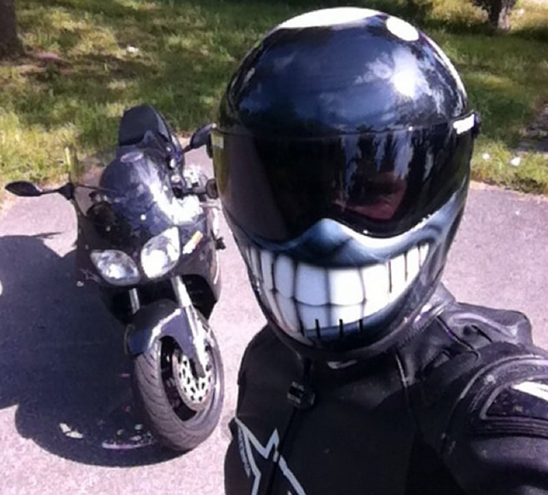 Motorcycles are about big open roads and big smiles, and it doesn't get bigger than this. The wicked smile on this helmet looks so darn cool. One of the few helmets on this list you'd actually want to be seen in. (Image: Badasshelmetstore)