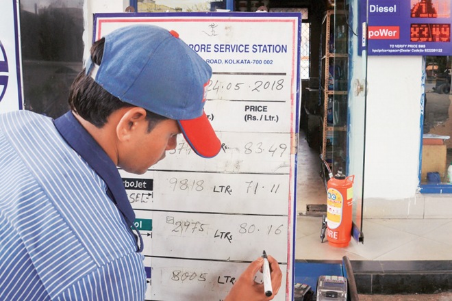 A petrol pump employee changes the prices on a board at a fuel station even as fuel prices record the highest-ever, in Kolkata, on Thursday A petrol pump employee changes the prices on a board at a fuel station even as fuel prices record the highest-ever, in Kolkata, on Thursday