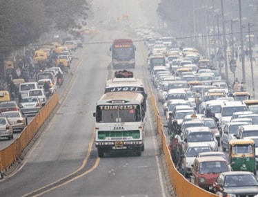 Cars and buses work their way through traffic in New Delhi. China and India may look like large pollutants, but if the amount of pollution is divided by the population and then compared with developed countries, one would get a very different picture, says the author (Bloomberg)