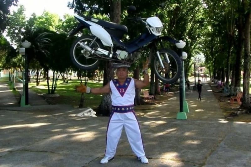 Longest time balancing a motorcycle on head: This record involves a motorcycle, however riding it has got nothing to do with it or even sitting on it. Gerard Jessie from Phillipines holds the record of balancing a small motorcycle on his head. 14.93 seconds. (Image: Record Setter)