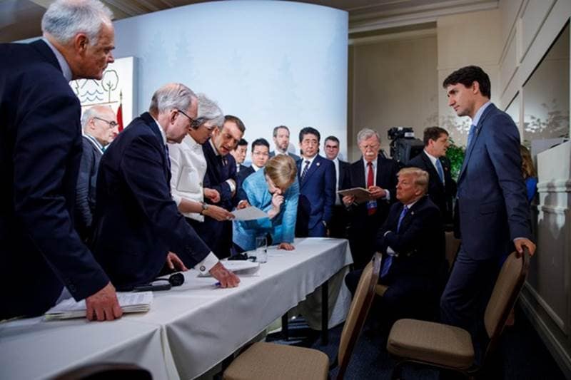 In this photograph German Chancellor Angela Merkel is seen talking to President Donald Trump during the second day of the G7 meeting in Charlevoix city of La Malbaie, Quebec.
