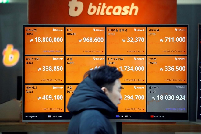 A man walks past an electric board showing exchange rates of various cryptocurrencies including Bitcoin (top L) at a cryptocurrencies exchange in Seoul, South Korea December 13, 2017. REUTERS/Kim Hong-Ji A man walks past an electric board showing exchange rates of various cryptocurrencies including Bitcoin (top L) at a cryptocurrencies exchange in Seoul, South Korea December 13, 2017. REUTERS/Kim Hong-Ji