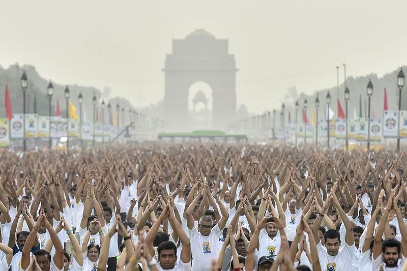 Enthusiasts perform during a mass yoga session on the 4th International Day of Yoga in the backdrop of India Gate, at Rajpath in New Delhi, on Thursday, June 21, 2018. (PTI Photo)