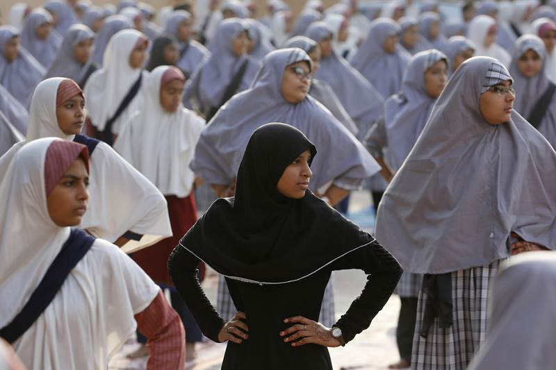 Muslim students practice yoga ahead of International Yoga Day at a school in Ahmedabad, India, Wednesday, June 20, 2018. International Yoga Day will be celebrated on June 21. (AP Photo)