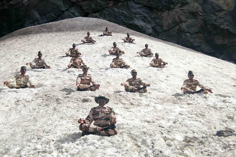 ITBP personnel perform yoga to commemorate International Day of Yoga, at the Himalayas near Ladakh region on Thursday. (PTI image)